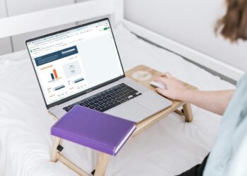 a person using a laptop on a bed