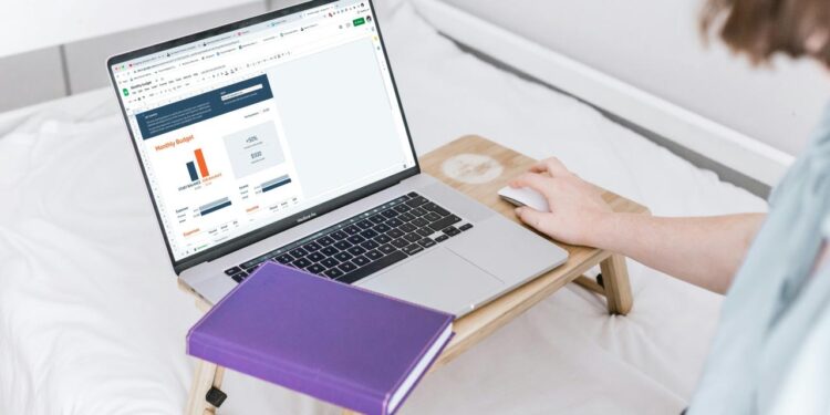 a person using a laptop on a bed